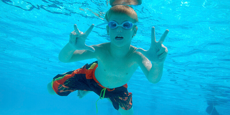 boy swimming under water